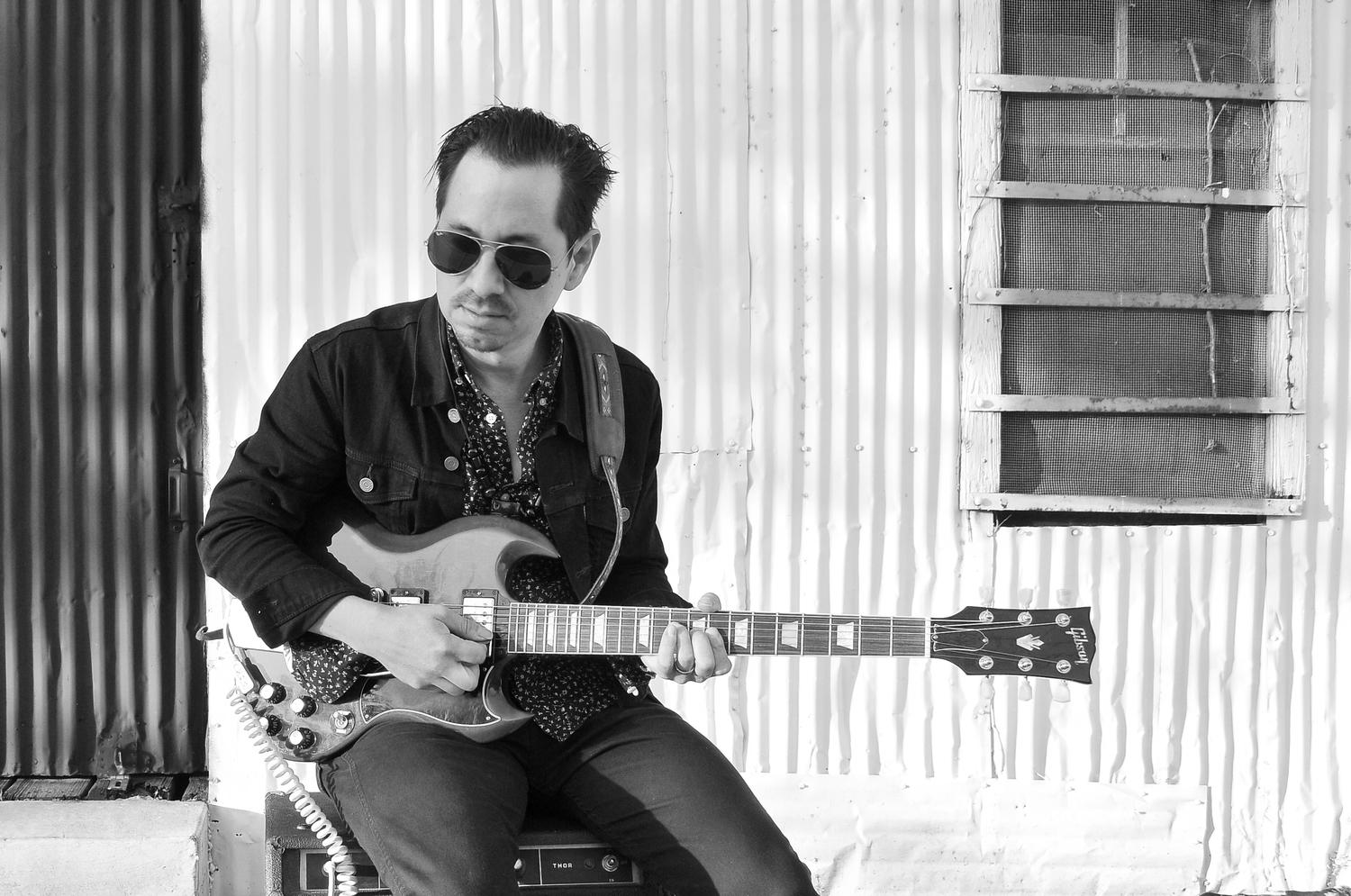 Musician Adrian Quesada grew up on the bordertown of Laredo, Texas