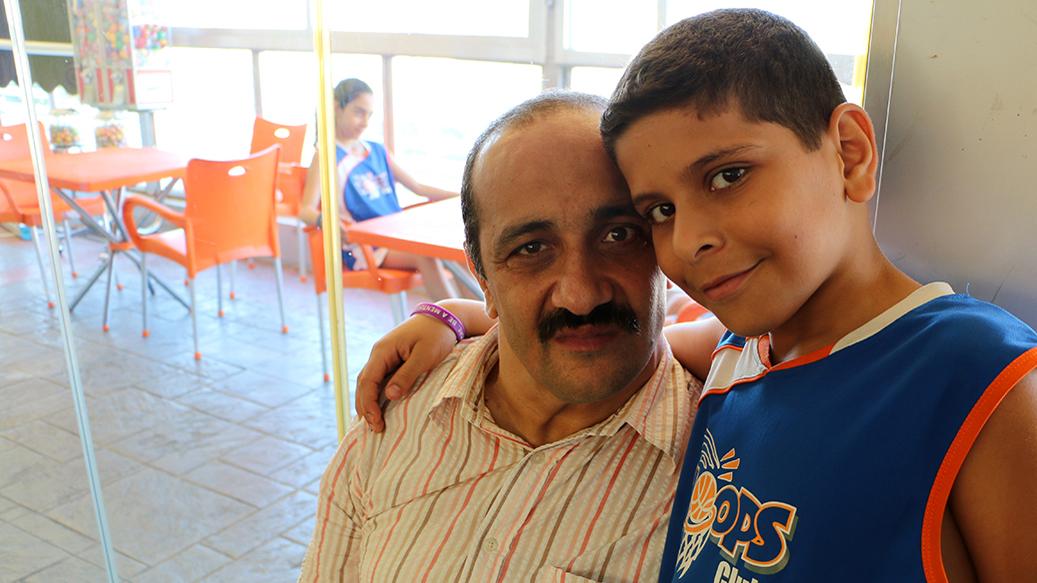Ahmad and his dad at Hoops, an indoor basketball school made possible by a Lebanese NGO called Nawaya.