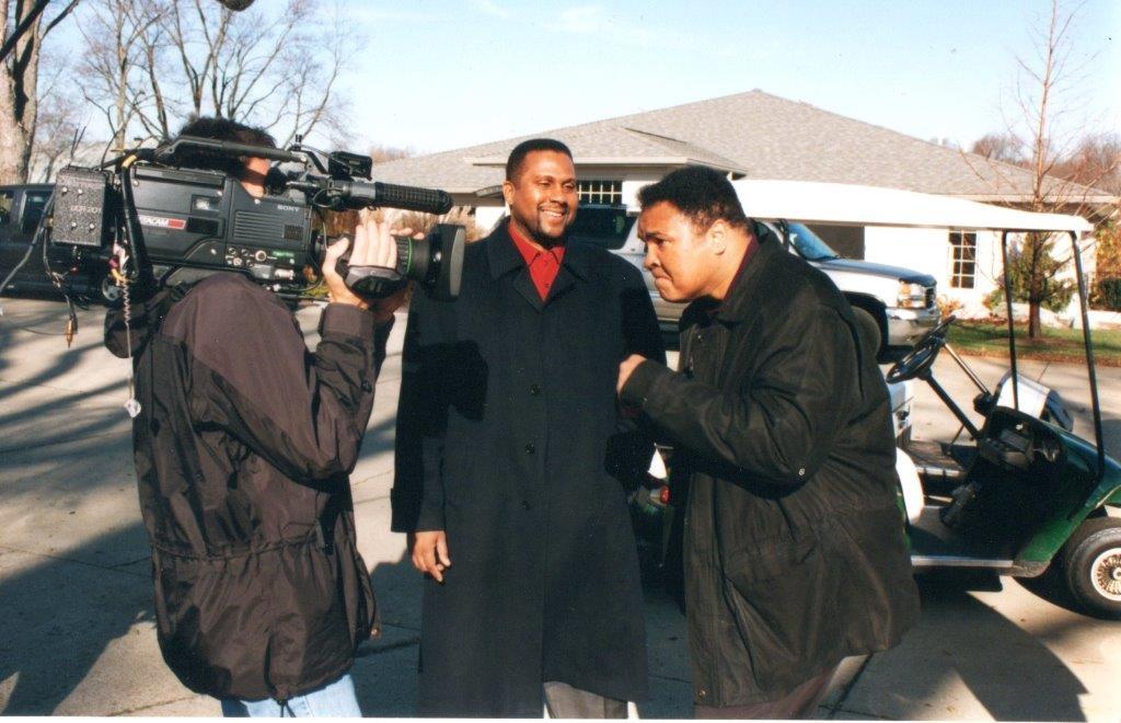 Tavis Smiley and Muhammad Ali speak during a TV interview.