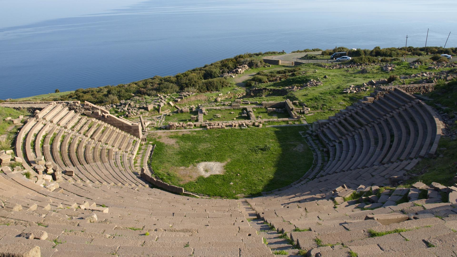 The ancient Theatre of Assos overlooking the Aegean Sea, with the nearby island of Lesbos on the horizon, at right.