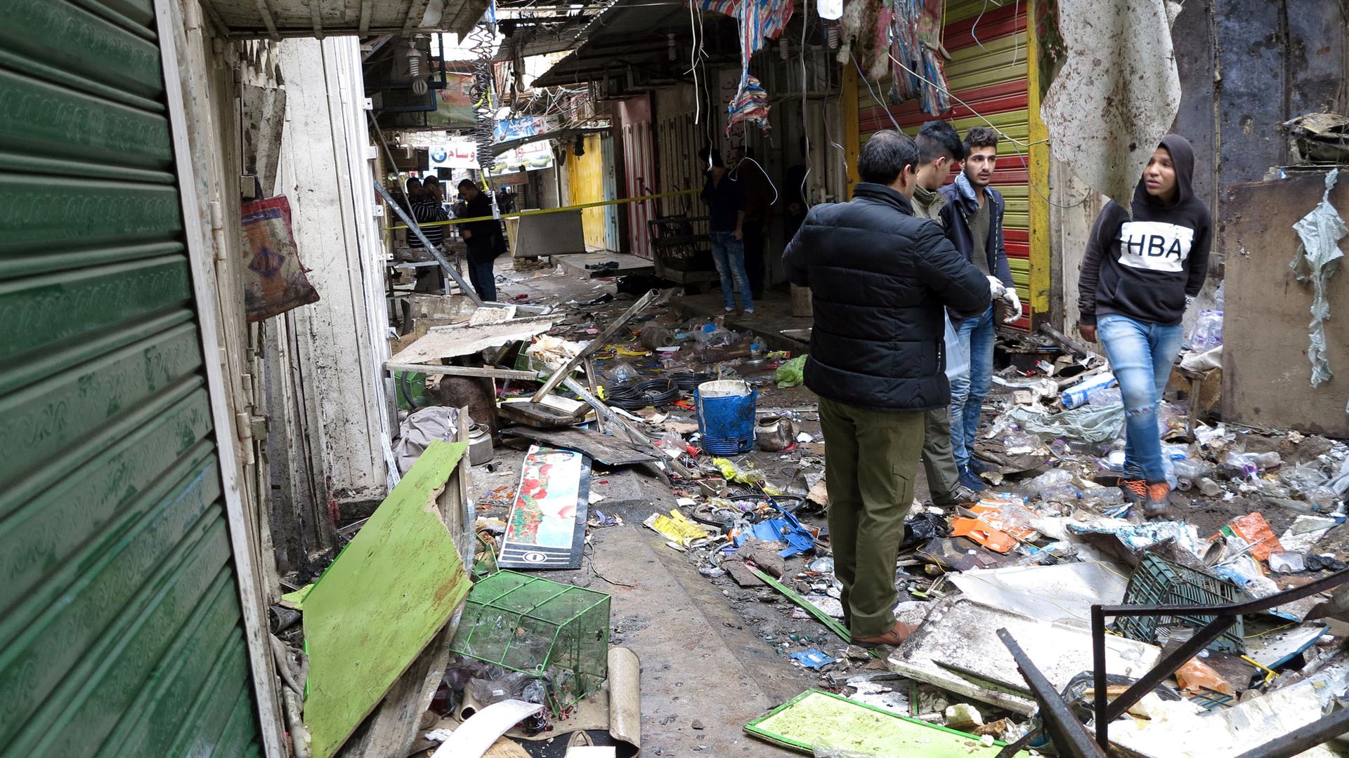 Iraqi security forces inspect the site of a bomb attack at a market in central Baghdad, Iraq December 31.