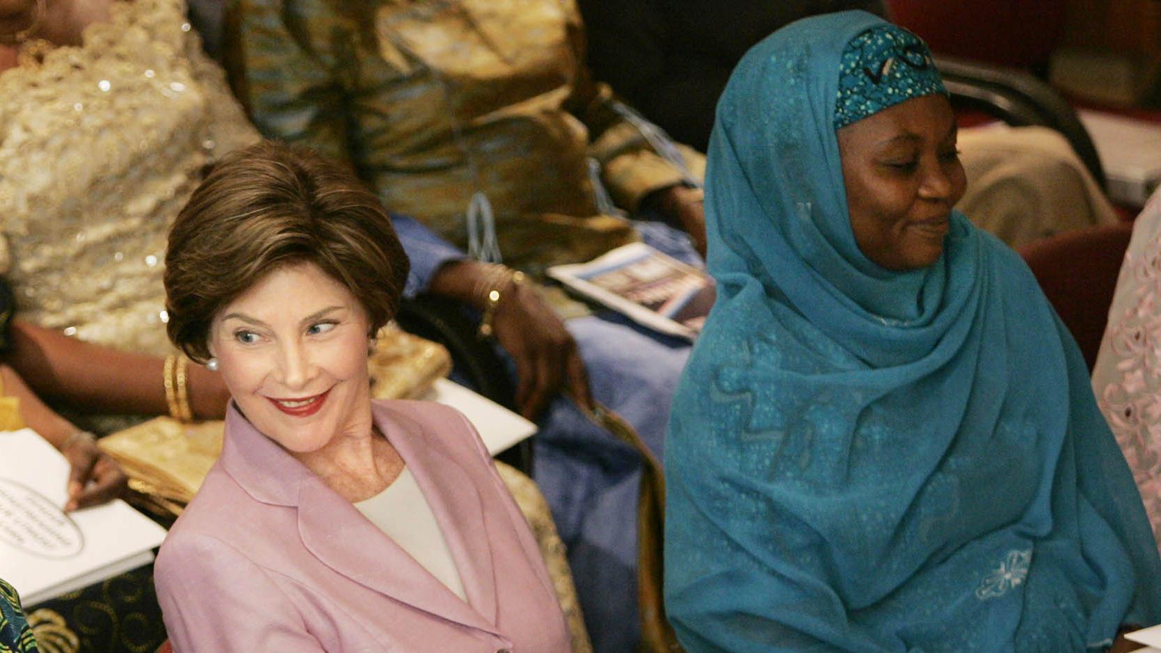 Hajia Bilkisu Yusuf sits with former first lady, Laura Bush, at the National Center for Women's Development in Abuja, Nigeria, January 2006.