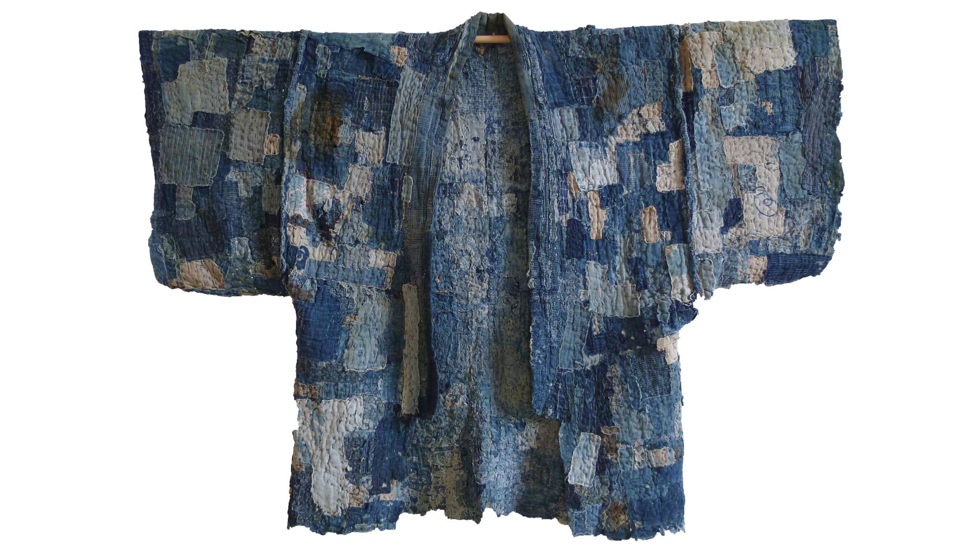 This is a patched work coat, or noragi, that likely never began as a full garment, but was rather made from multiple, very small patches — some of them the size of a postage stamp — that were all sewn together to create an area of cloth, and then layered.
