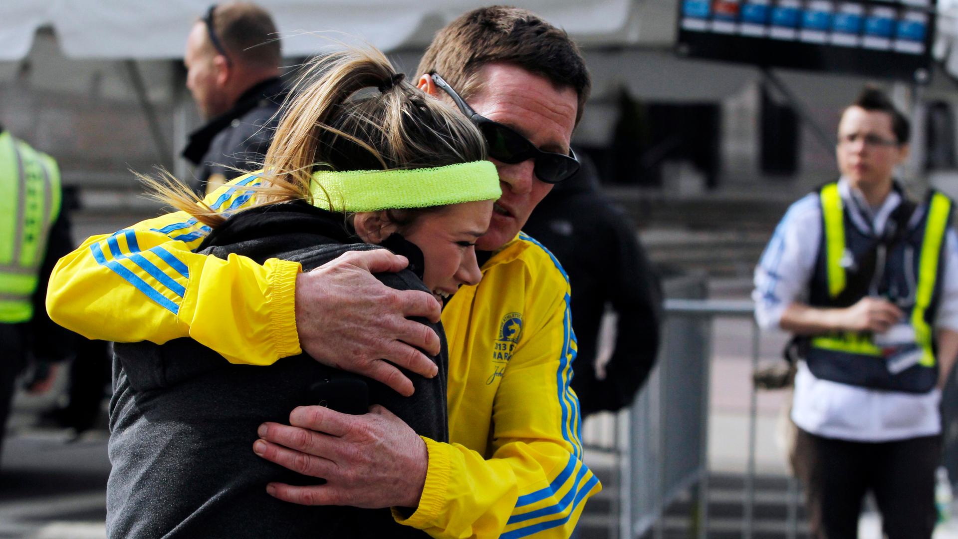 A woman is comforted by a man near a triage tent set up for the Boston Marathon after the April 2013 bombings