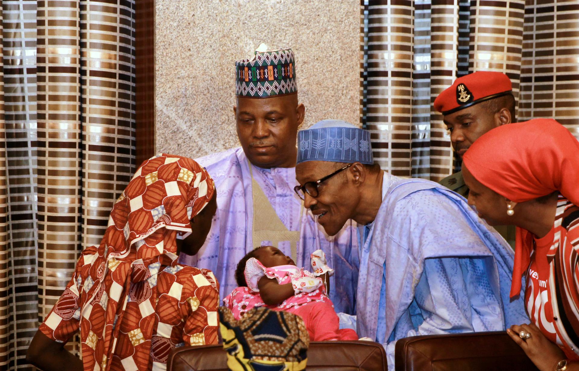Amina Ali Darsha Nkeki, a Nigerian schoolgirl rescued after over two years of captivity with Boko Haram militants, presents her child to President Muhammadu Buhari in Abuja, Nigeria May 19, 2016. 