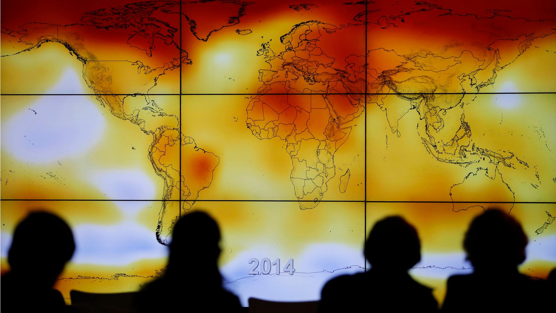 Participants view a world map with climate anomalies during the World Climate Change Conference 2015 (COP21) at Le Bourget, near Paris. The conference is charged with producing a consensus agreement between 195 countries to limit the dangerous warming of 