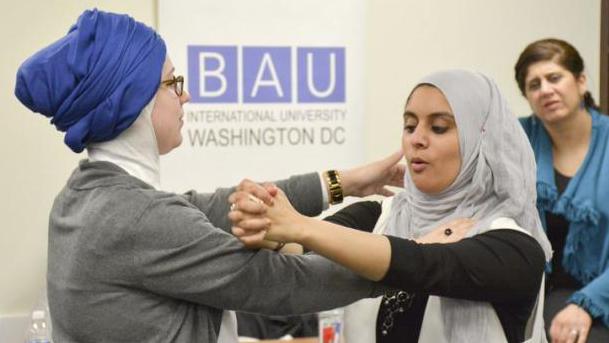 Rana Abdelhamid (C) demonstrates a move to a student during a self-defense workshop designed for Muslim women in Washington, DC, in March.