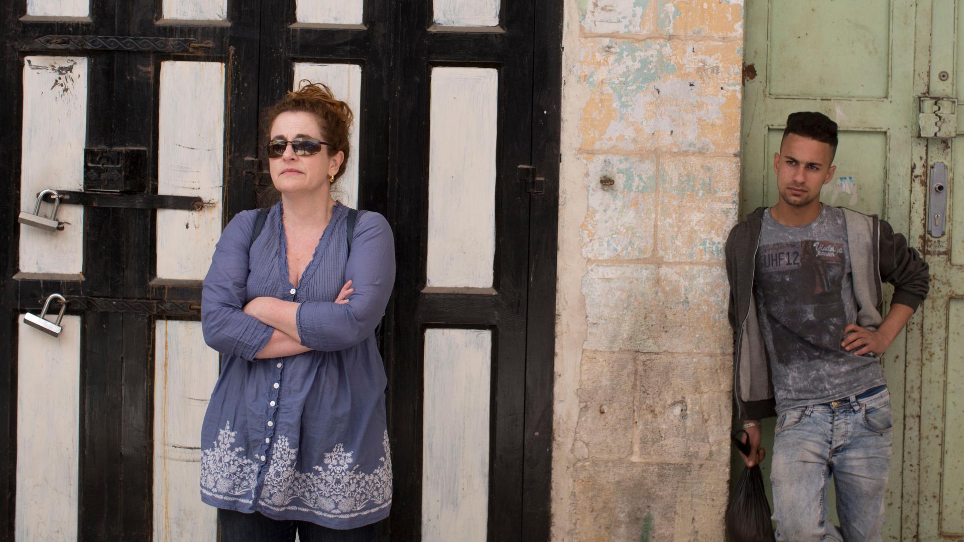 Novelist Ayelet Waldman and a Palestinian man in Hebron. “For most of my life, I loved Israel, I longed for Israel, I planned to live in Israel,” she says.