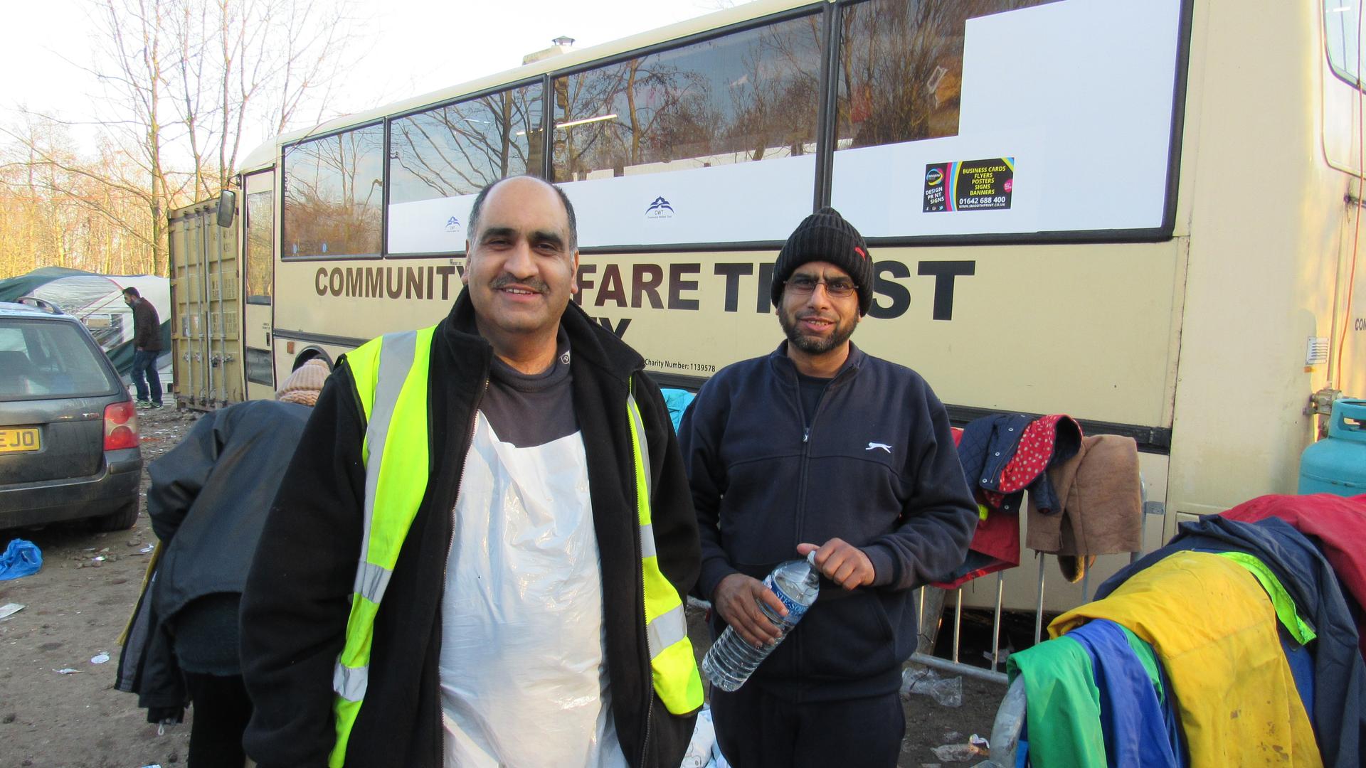 Ghafoor Hussain and his brother Fazel outside Ghafoor's bus-turned-mobile kitchen. They're supplying 3,000 hot meals a day, and 10,000 cups of tea.