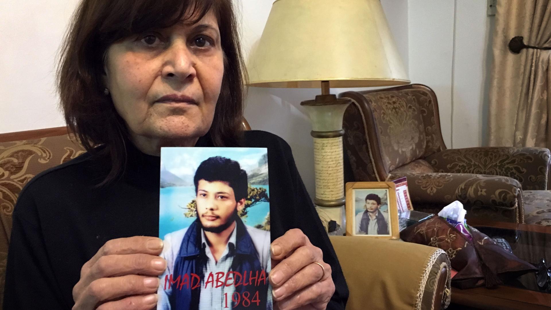 Samia Abdullah holds up a picture of her brother Emad who disappeared in 1984 when he was 20 years old. His family thinks he's still alive in a Syrian prison.