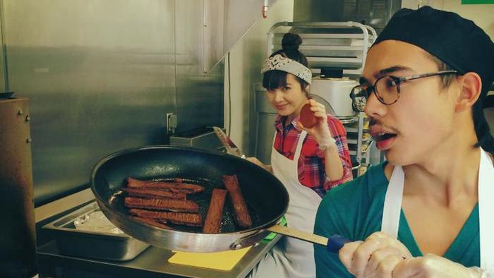 Kale Walch cooks a pan of "bacon," one of the meatless meats that he and his sister Aubry Walch (in the back) whip up for The Herbivorous Butcher. They're hoping to open what they say is the world's first vegan butcher shop in the spring.