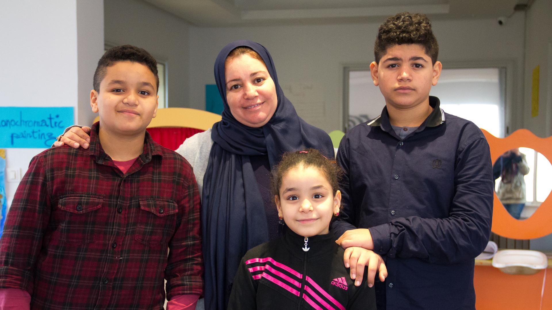 Fatima Elahmer and her three children, Mohamed, Anoud, and Ali. They've been living in Tunis since last summer.