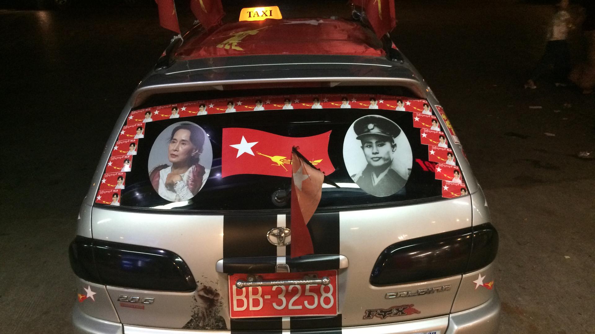A taxi in Yangon decorated for Myanmar's election: a picture of Aung San Suu Kyi (l), and her late father, Aung San (r), who is revered as the father of modern Burma.