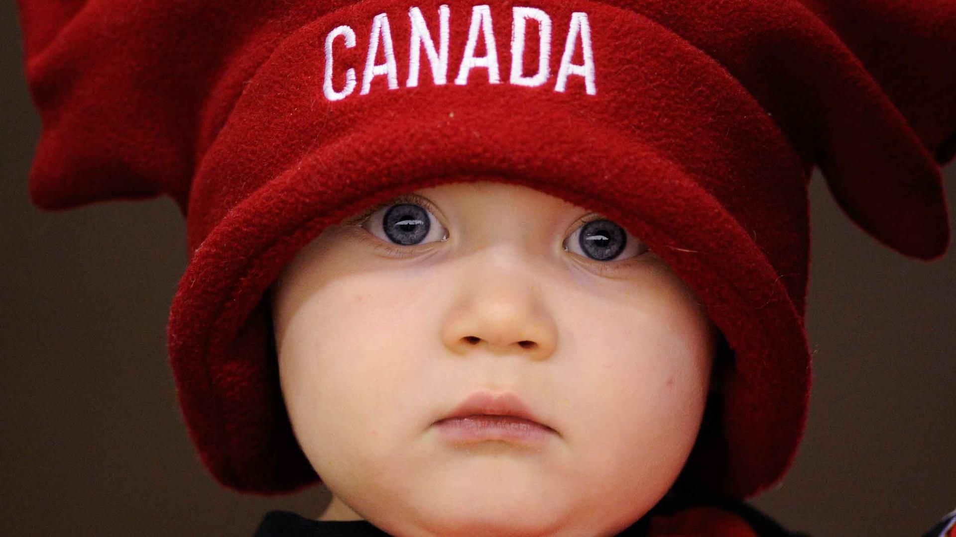 Sixteen-month-old Canada fan Rogan Clark watches team Canada and team Switzerland warm up before their exhibition hockey game in Red Deer, Alberta.