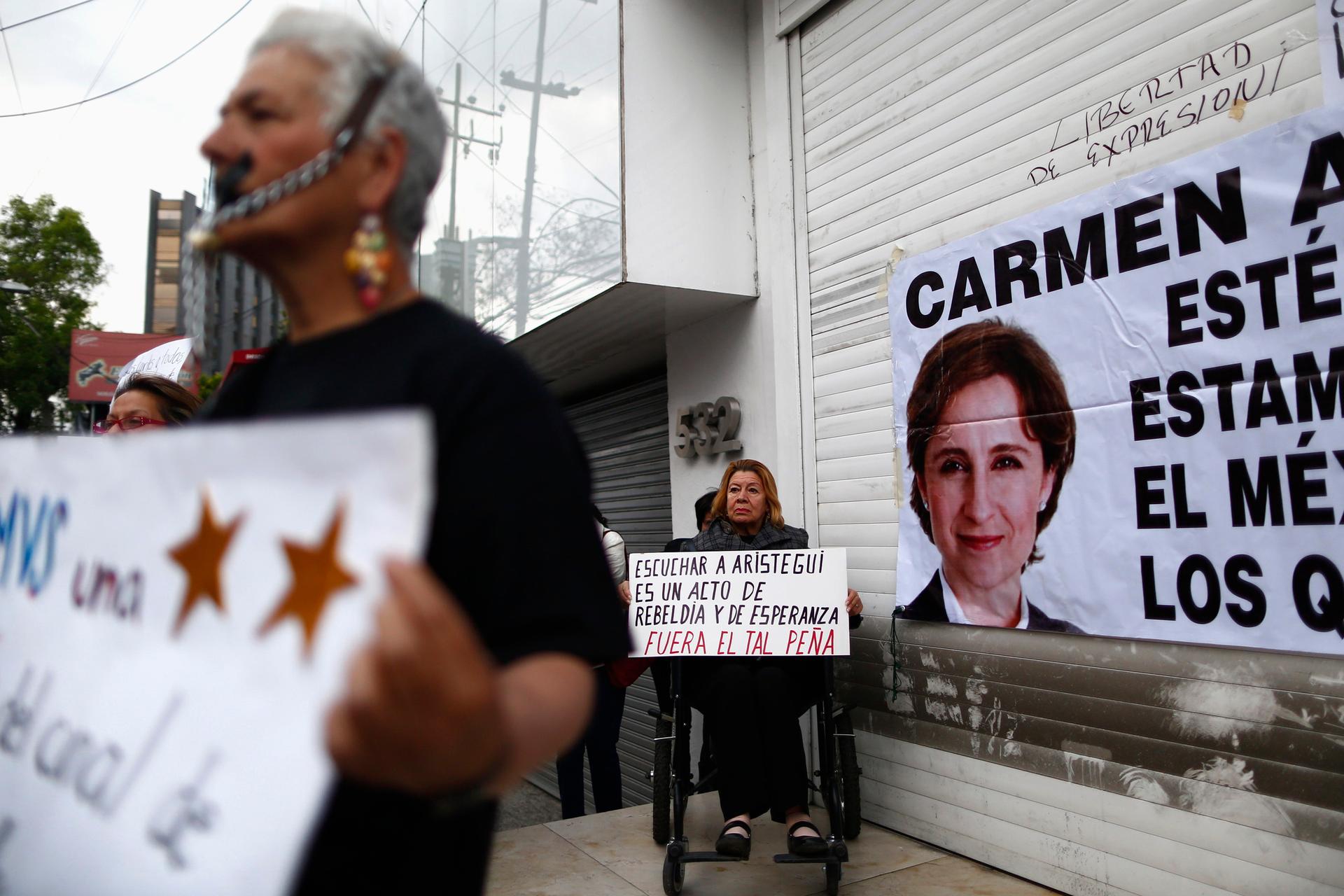 A supporter holds a sign during a protest on March 16, 2015, outside MVS Radio in Mexico City gainst the dismissal of Mexican journalist Carmen Aristegui.