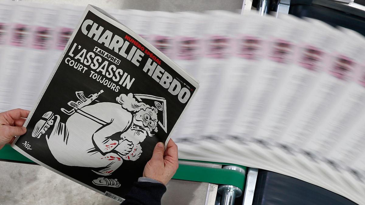 A copy of the latest edition of French weekly newspaper Charlie Hebdo with the title "One year on, The assassin still on the run."