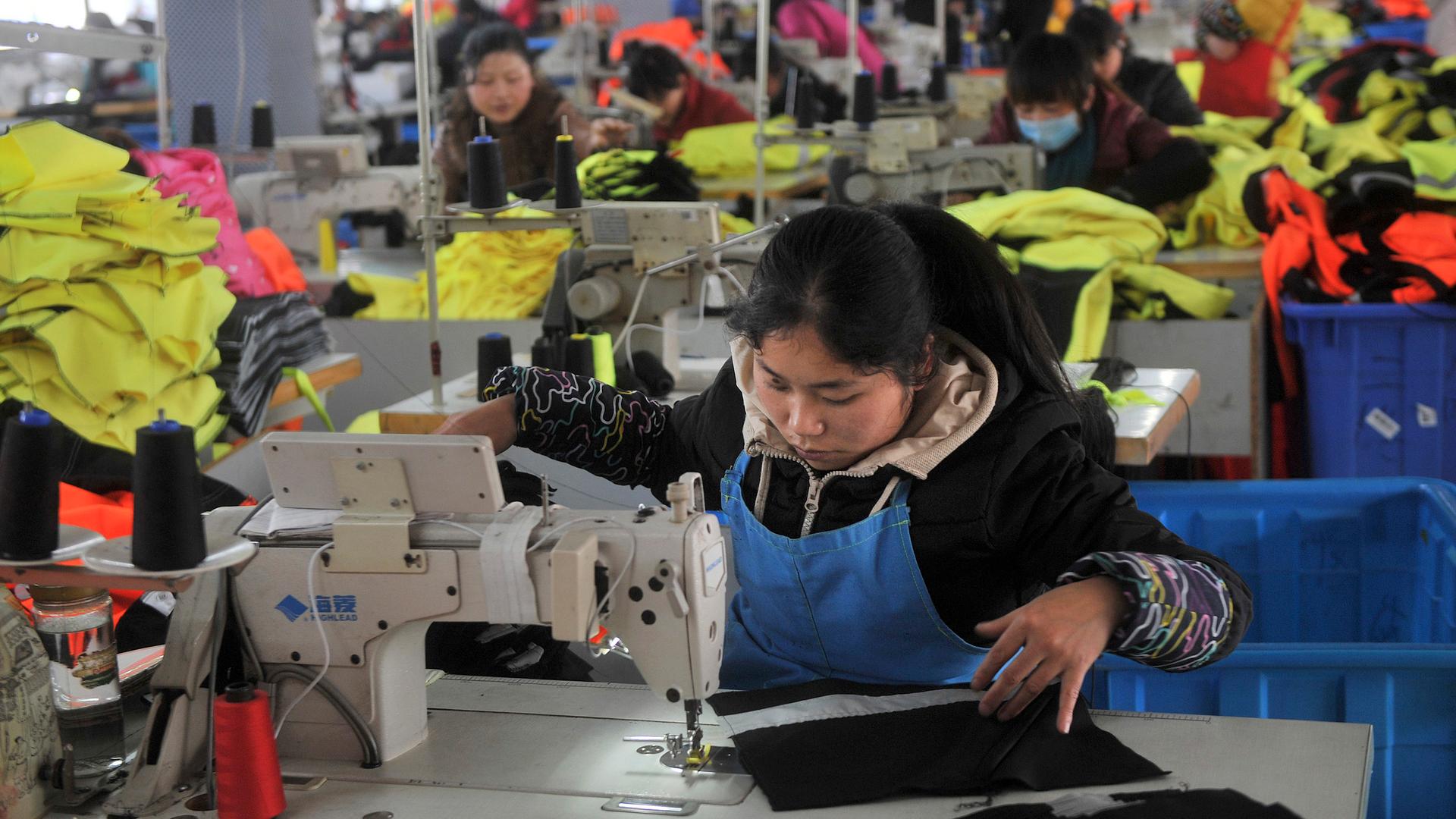 An employee works at a garment factory, which exports products overseas, in Hefei, Anhui province January 19, 2015.  