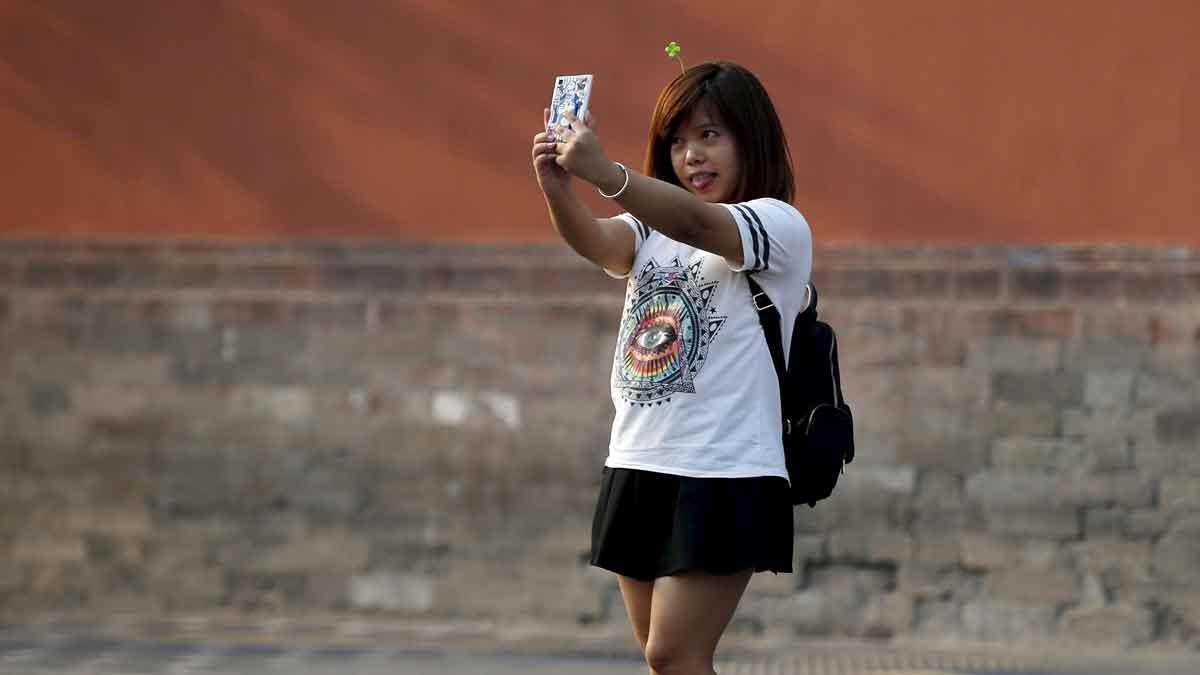 A woman takes a selfie in Beijing, September 2015. 
