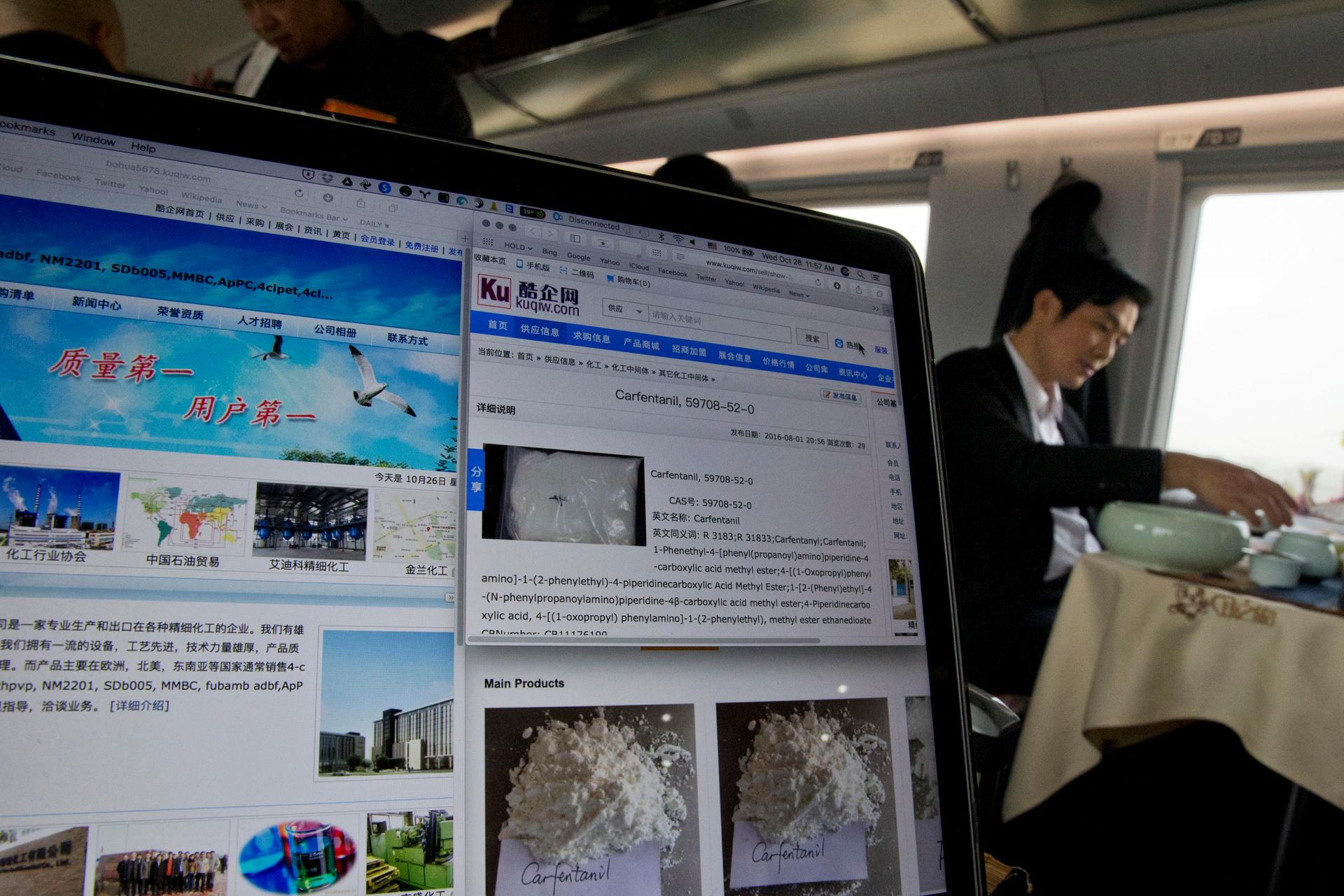 A man drinks tea near a computer screen displaying websites of companies selling the lethal synthetic opioid carfentanil online on a train leaving Beijing on Wednesday, Oct. 26, 2016. Use of the deadly chemical carfentanil by drug dealers has exploded acr