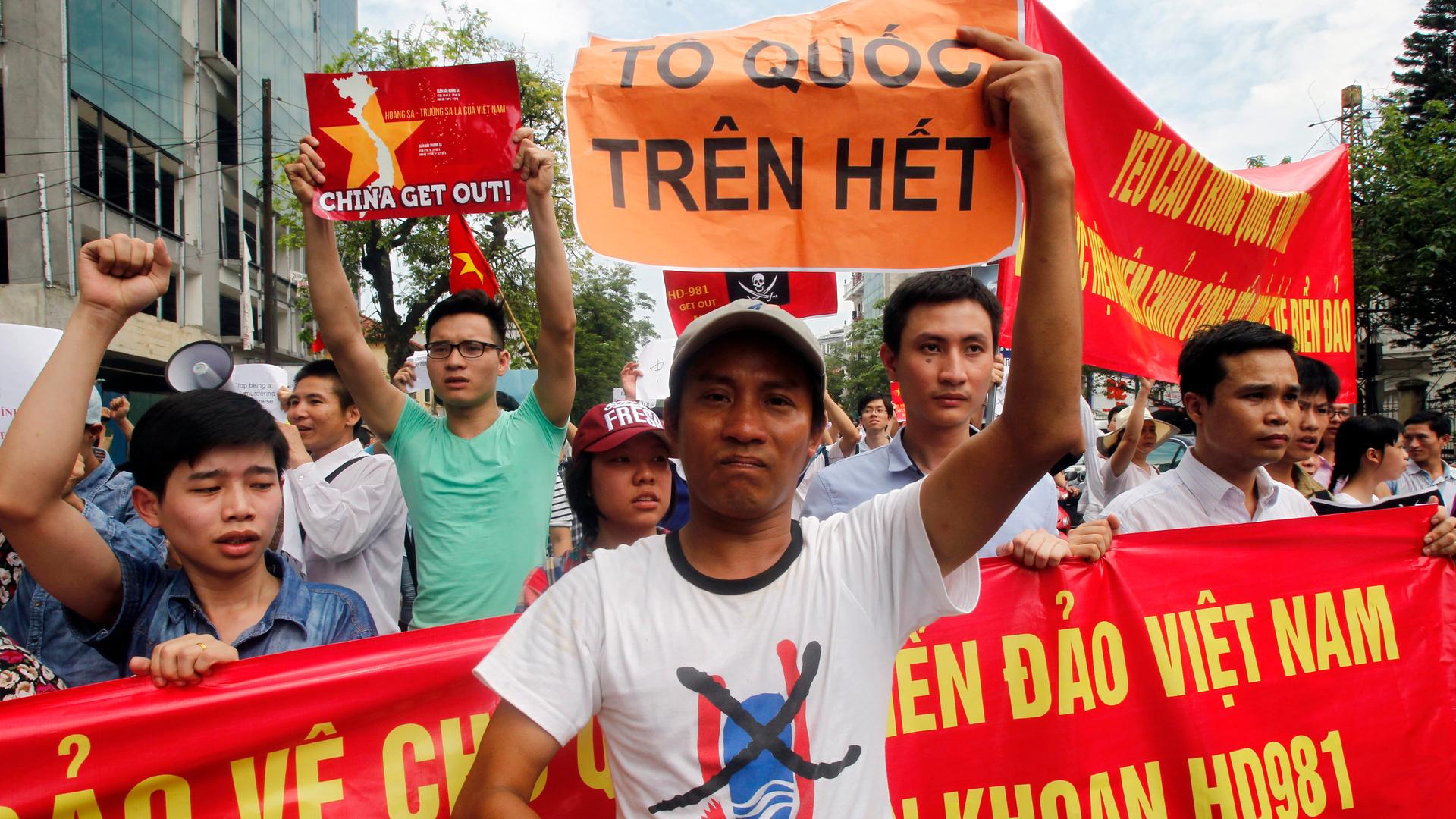A protester holds a placard reading "nation first" during an anti-China protest in Hanoi to denounce China's setting up of a giant oil rig in the South China Sea.