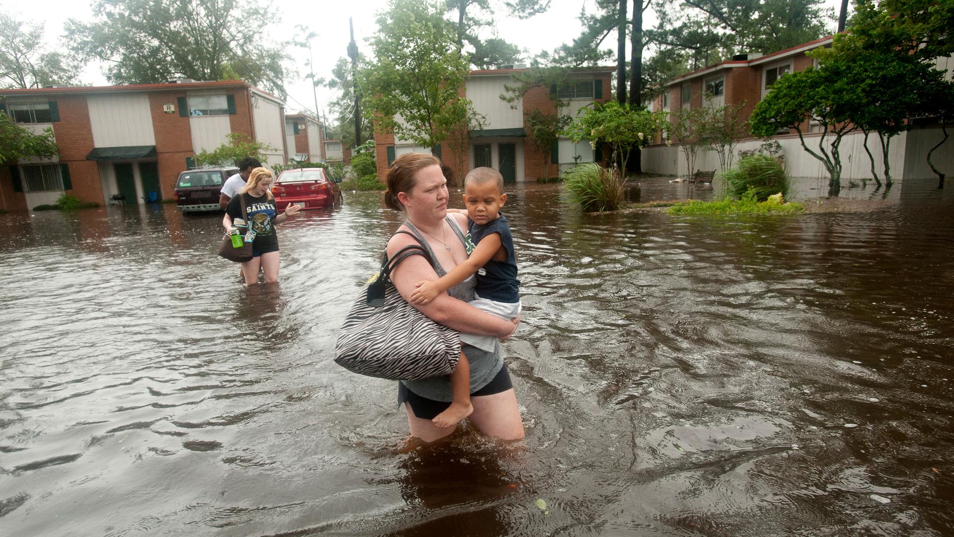 A woman wades through flood water in New Orleans
