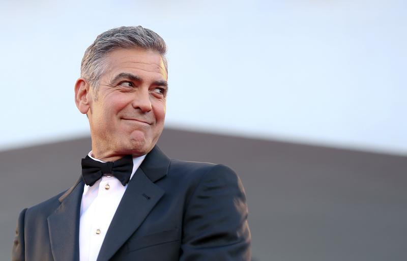 U.S. actor George Clooney smiles as he arrives on the red carpet for the premiere of "Gravity" at the 70th Venice Film Festival in Venice August 28, 2013. Clooney and Sandra Bullock star in Alfonso Cuaron movie "Gravity" which debuts at the festival. 