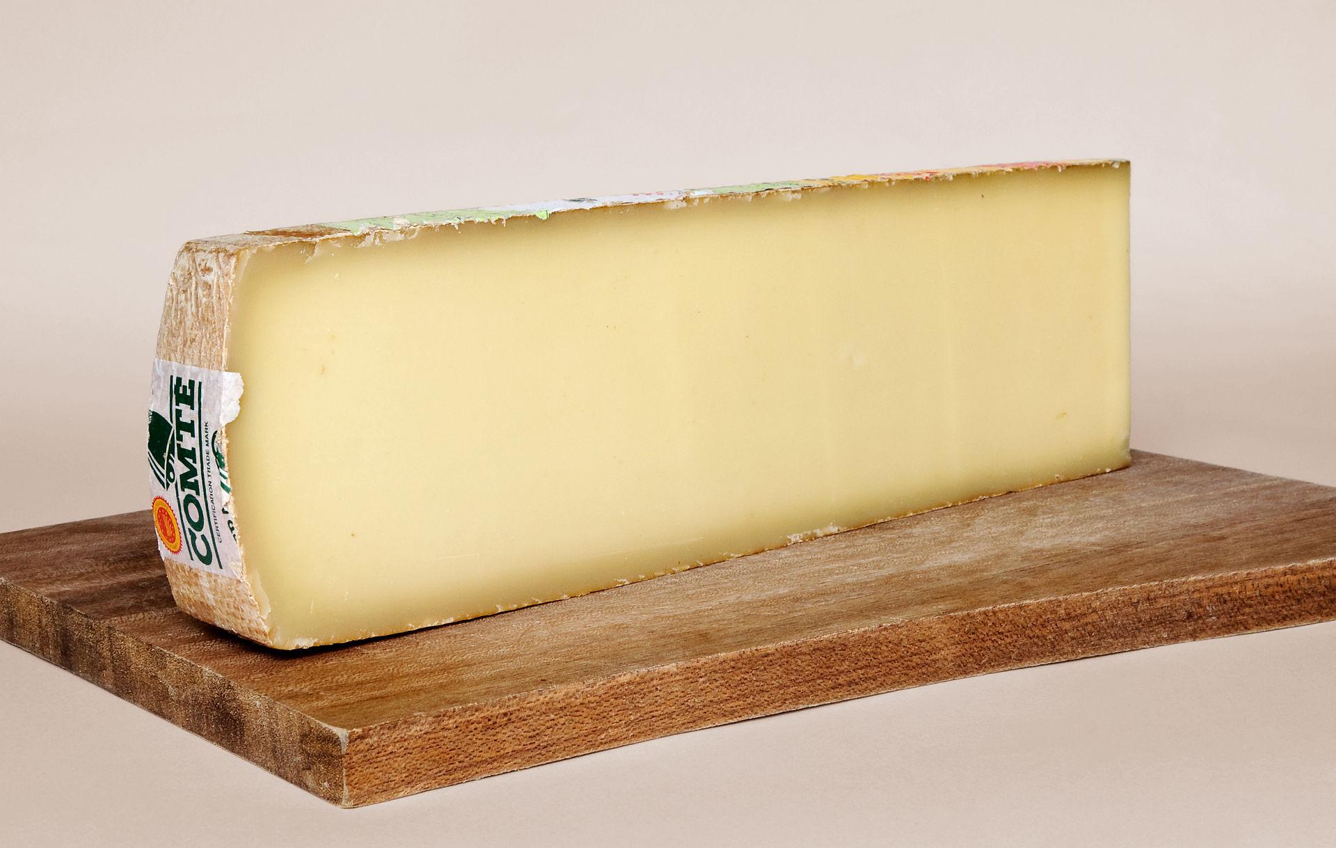 A slab of Comté, a French raw cow's milk cheese, labelled Protected Designation of Origin (PDO)