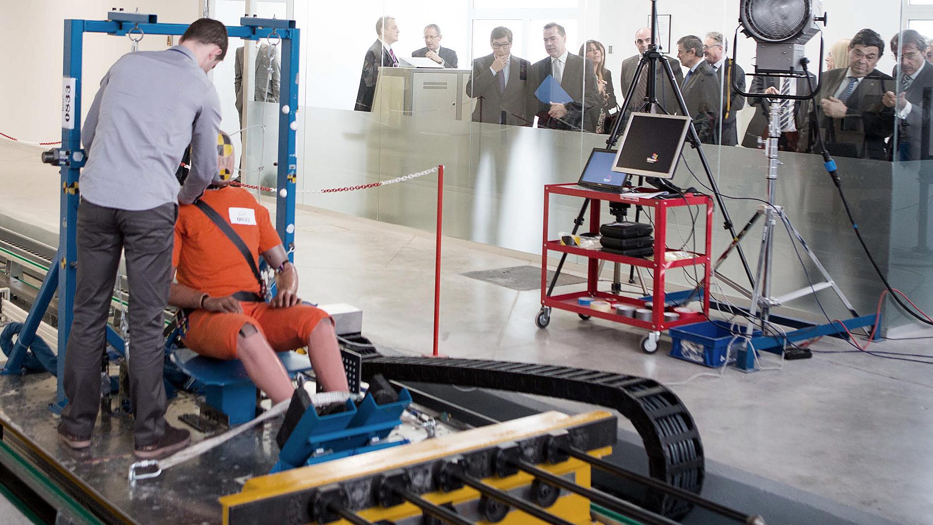 An engineer readies a crash test dummy at Spain's TESSA testing facility.