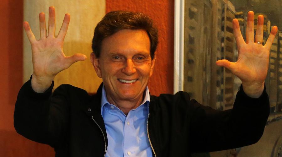 Marcelo Crivella, the new mayor of Rio de Janeiro, gestures to photographers after voting during the municipal elections on Oct. 30.