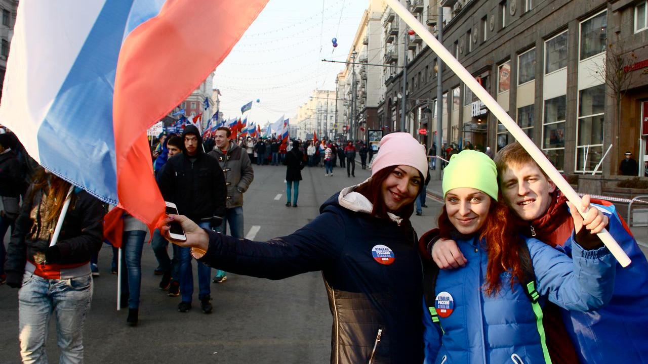 Faced with western sanctions, the Kremlin has pushed for a renewed sense of patriotism among younger Russians. At the National Unity Day celebrations in Moscow, students sport buttons that read, "An attack on Russia is an attack on me."