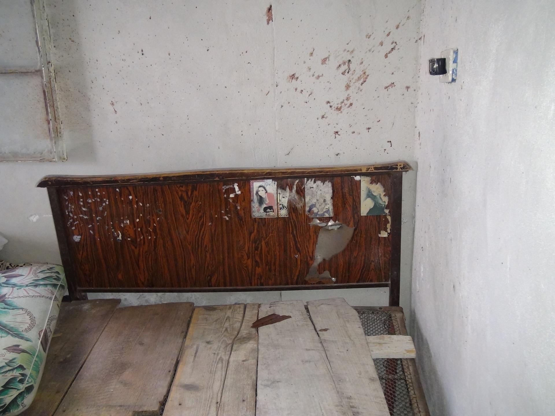 Blood splatter above the bed of Safwan Shebli, 23, who was killed by opposition groups during an August 4th offensive in Barouda village, northern Syria; photo taken September 8, 2013.