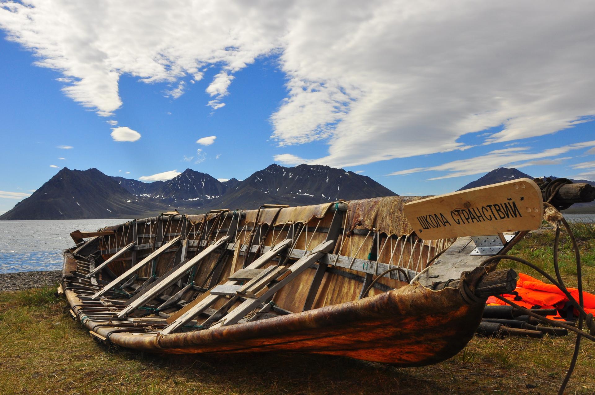 A handmade walrus skin boats lies along the shore of the Bering Sea. These boats, also known as bidarkas, are used for hunting marine mammals. In the summer, teams of men and women race them.