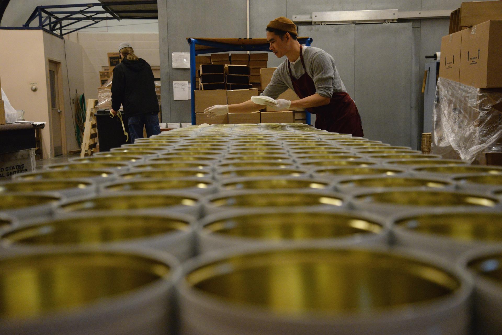 Man looking across rows of tins