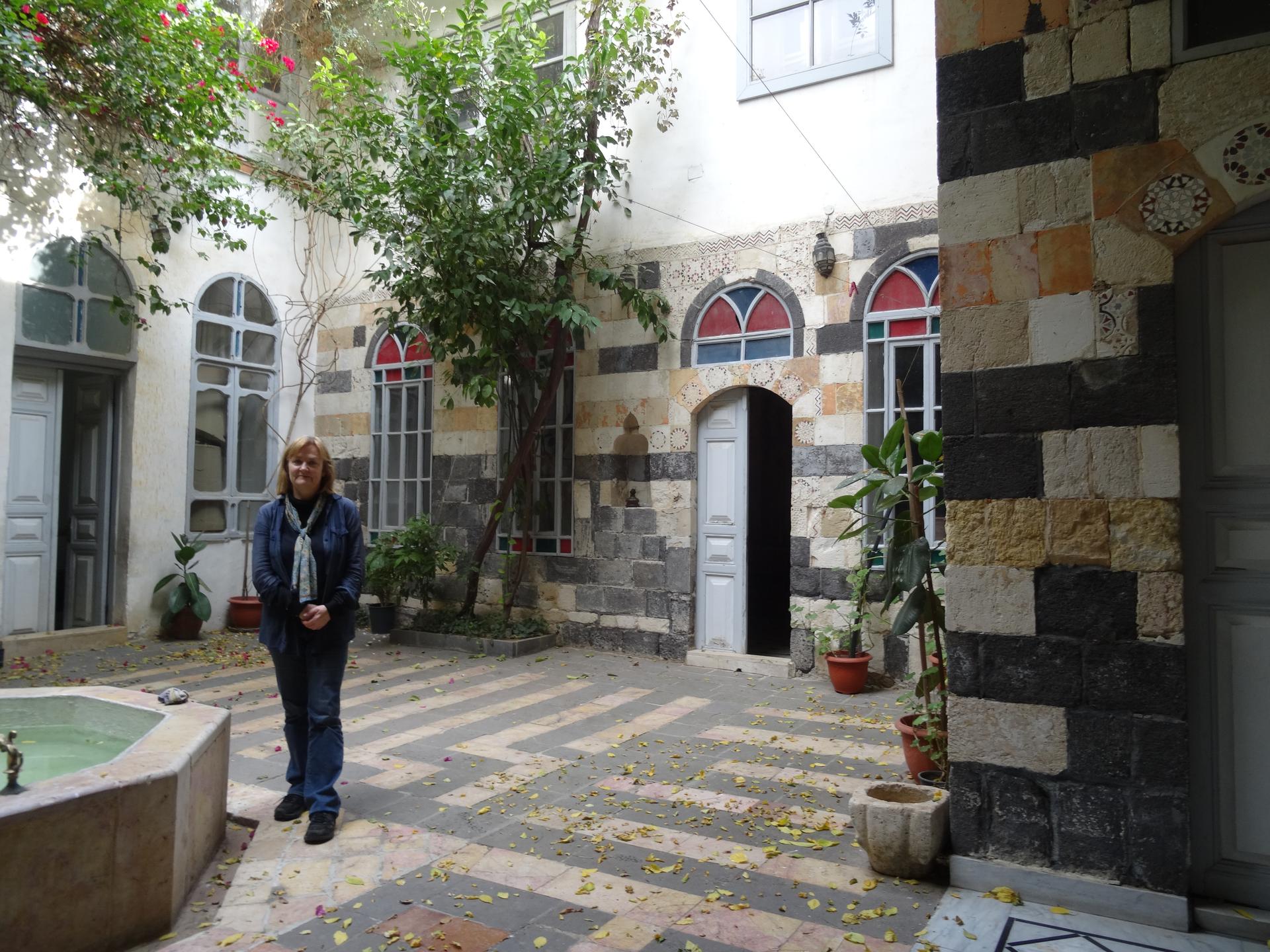Diana Darke in the courtyard of her house in Damascus, Syria.