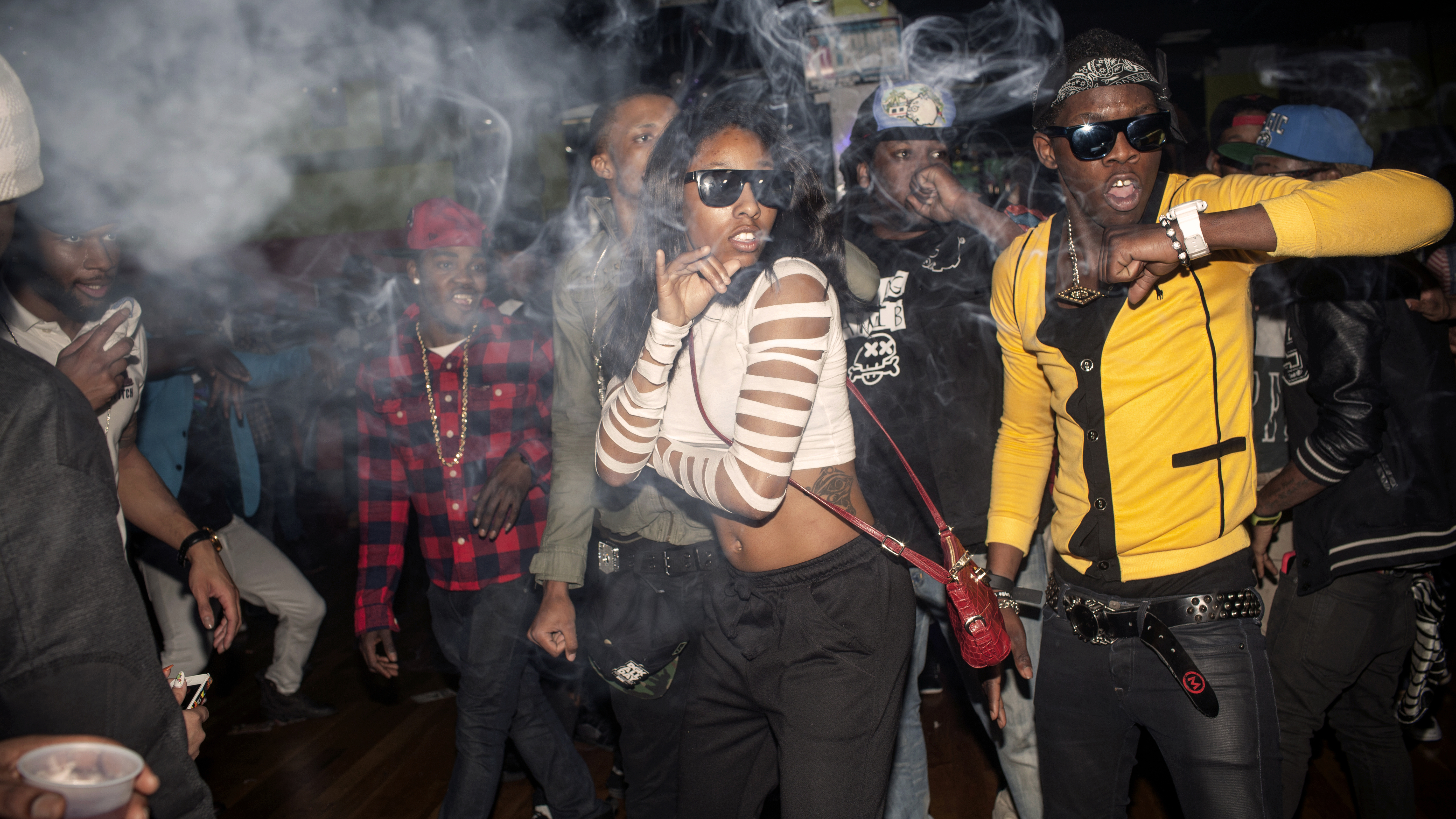 The Flavor Essence dance team moves through its choreography in unison as smoke clouds the air in a nightclub around 3am on a Thursday night. Videographers often attend the parties to make video of the dancers, which will be published on the internet on v