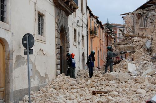 Emergency workers inspect the earthquake damaged buildings in L'Aquila Italy in April, 2009.