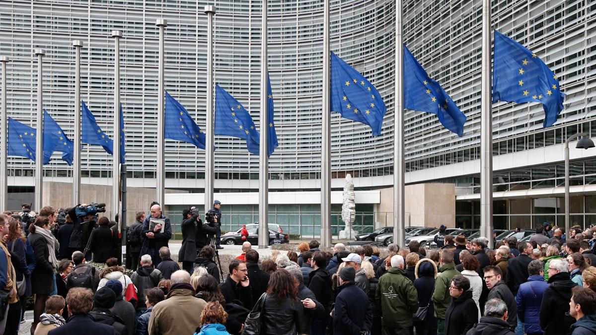 People observe a minute of silence outside the EU Commission Headquarters in Brussels following Tuesday's bomb attacks.