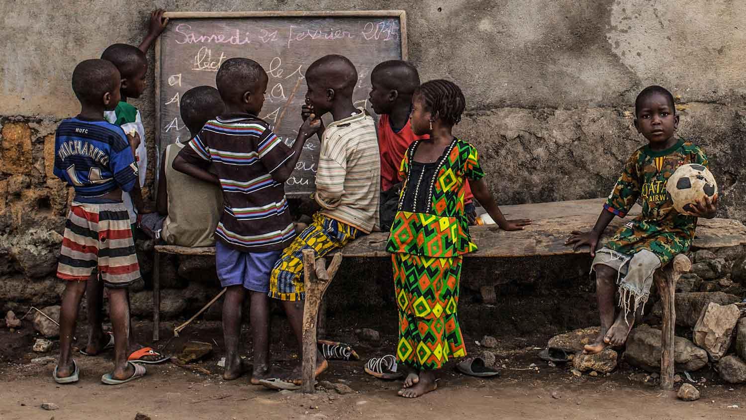 Young kids take part in informal French language lessons in the village of Meliandou, Guinea, ground zero for the West African Ebola outbreak.