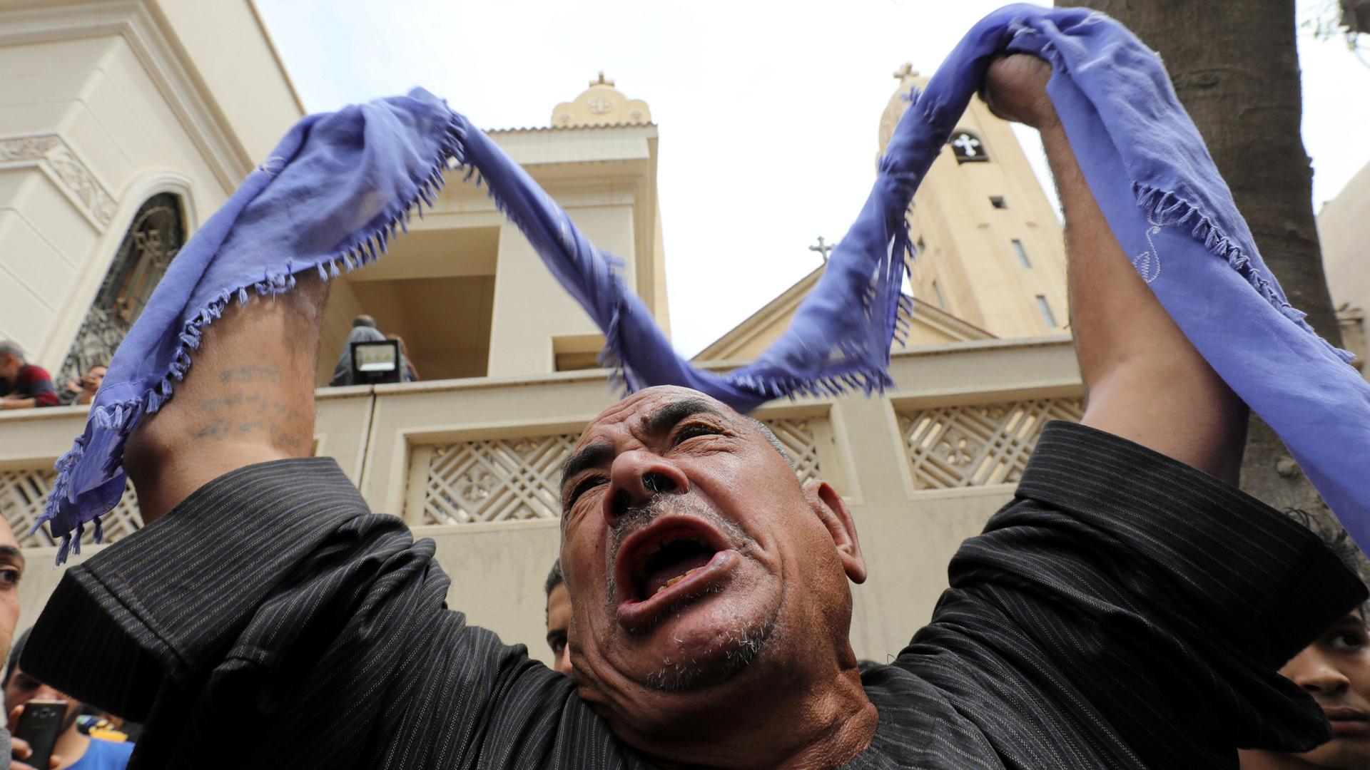 A relative of one of the victims reacts after a church explosion in Tanta, Egypt.