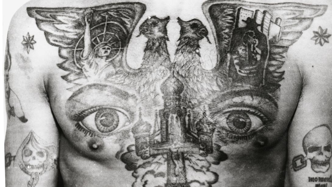 The eyes tattooed on this Soviet prisoner's chest signify "I can see everything" and "I am watching," the powerful tattoo of a criminal "overseer." The eight-pointed stars tattooed on the shoulders mark the bearer as an "authoritative’" thief.