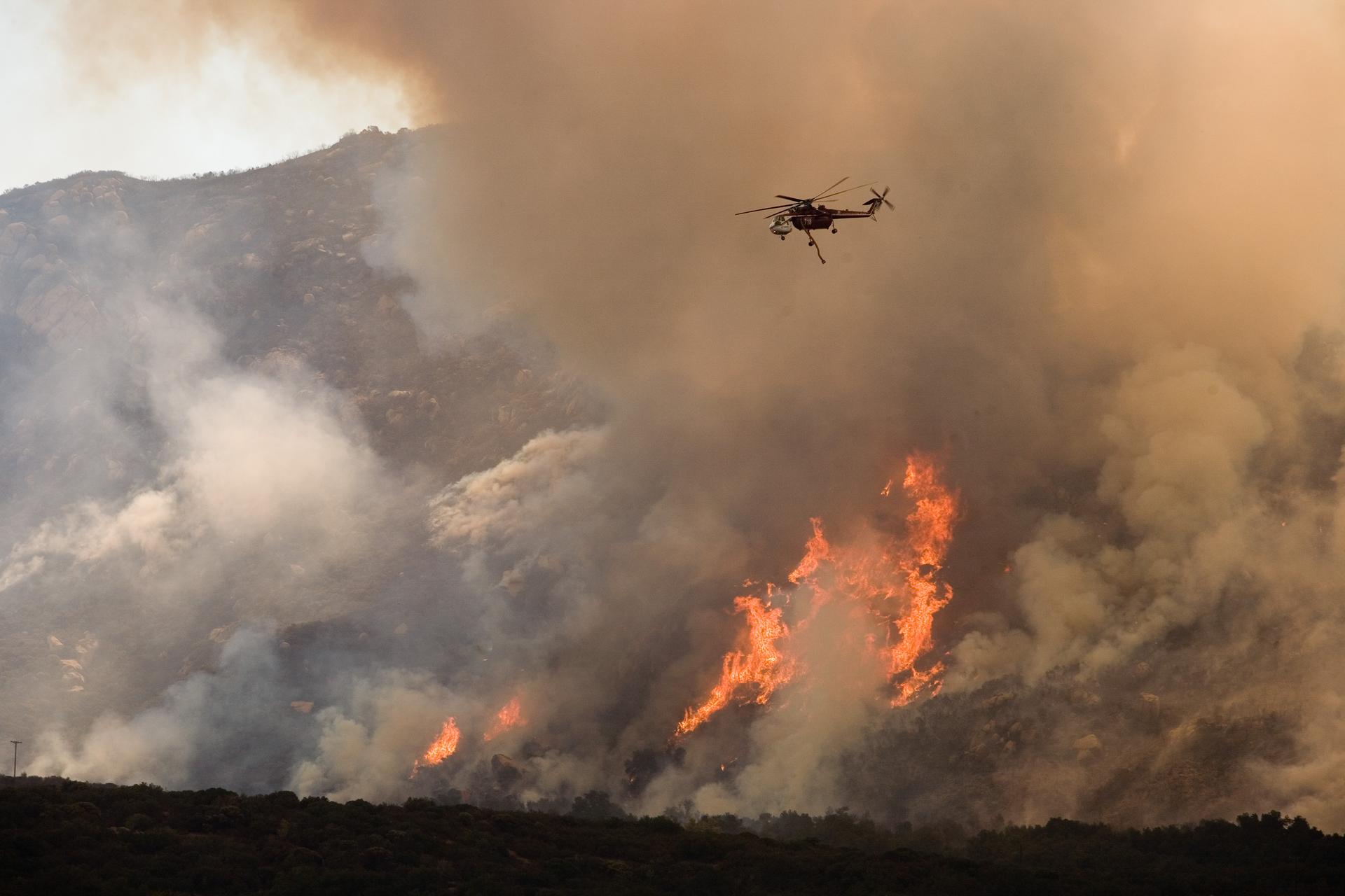 Helicopter dropping water on wildfire