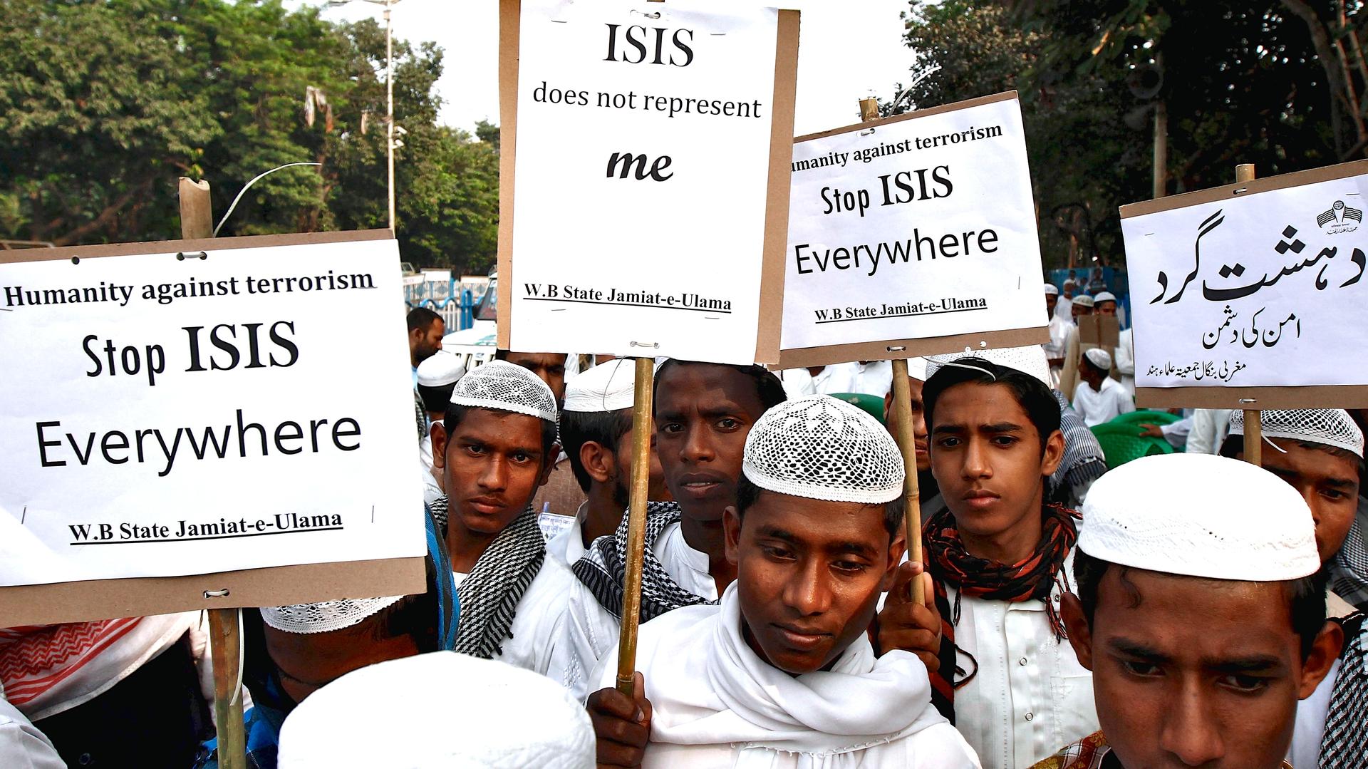 Activists from a Muslim group hold placards during a protest rally against the Paris attacks, in Kolkata, India on November 18, 2015.