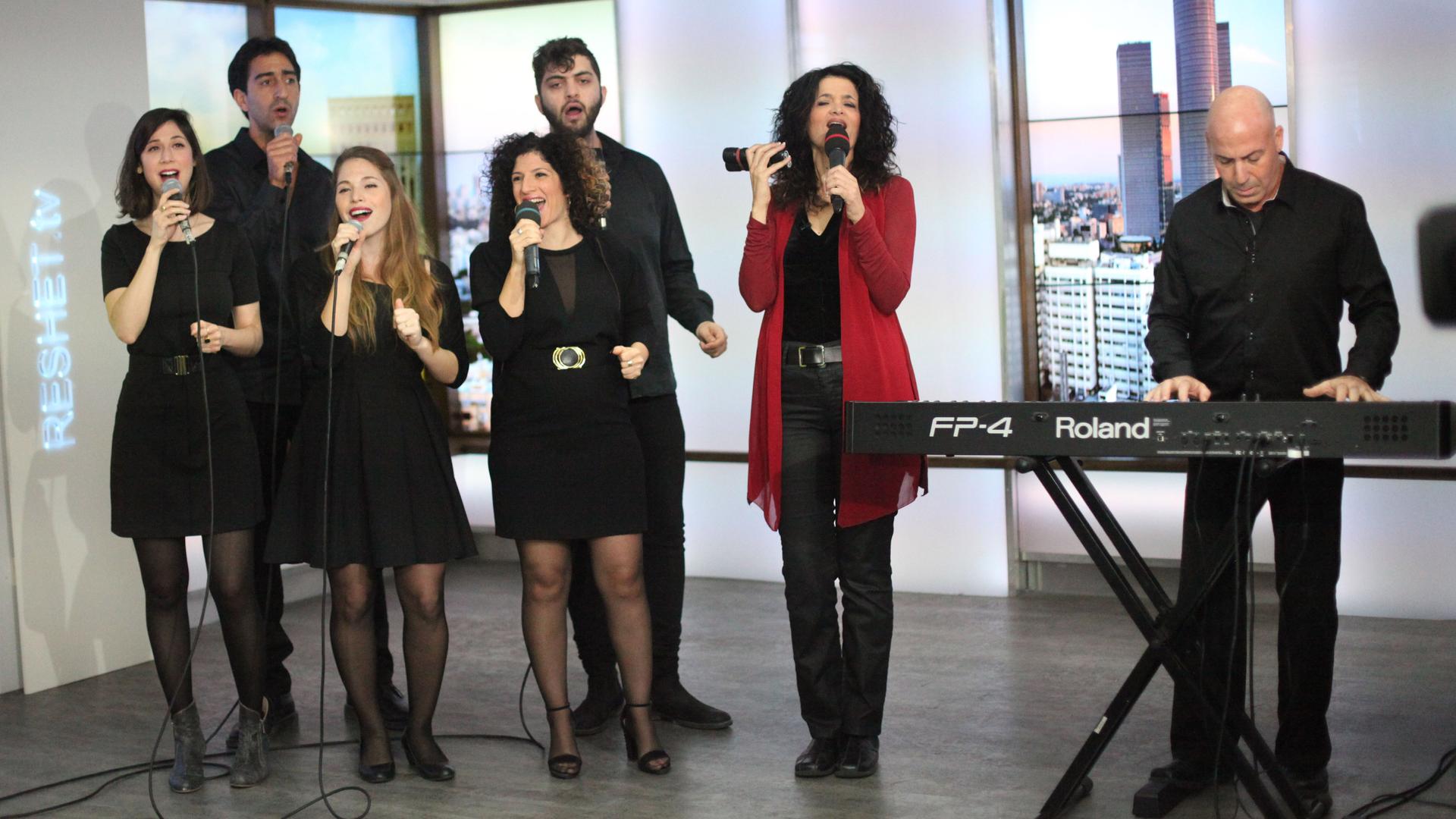 Ofer Portugaly on piano, and his wife Iris (standing next to him), started an Israeli gospel choir in 1999 after a trip to Nigeria. Here, they appear with part of their 15-member ensemble on Israeli TV.