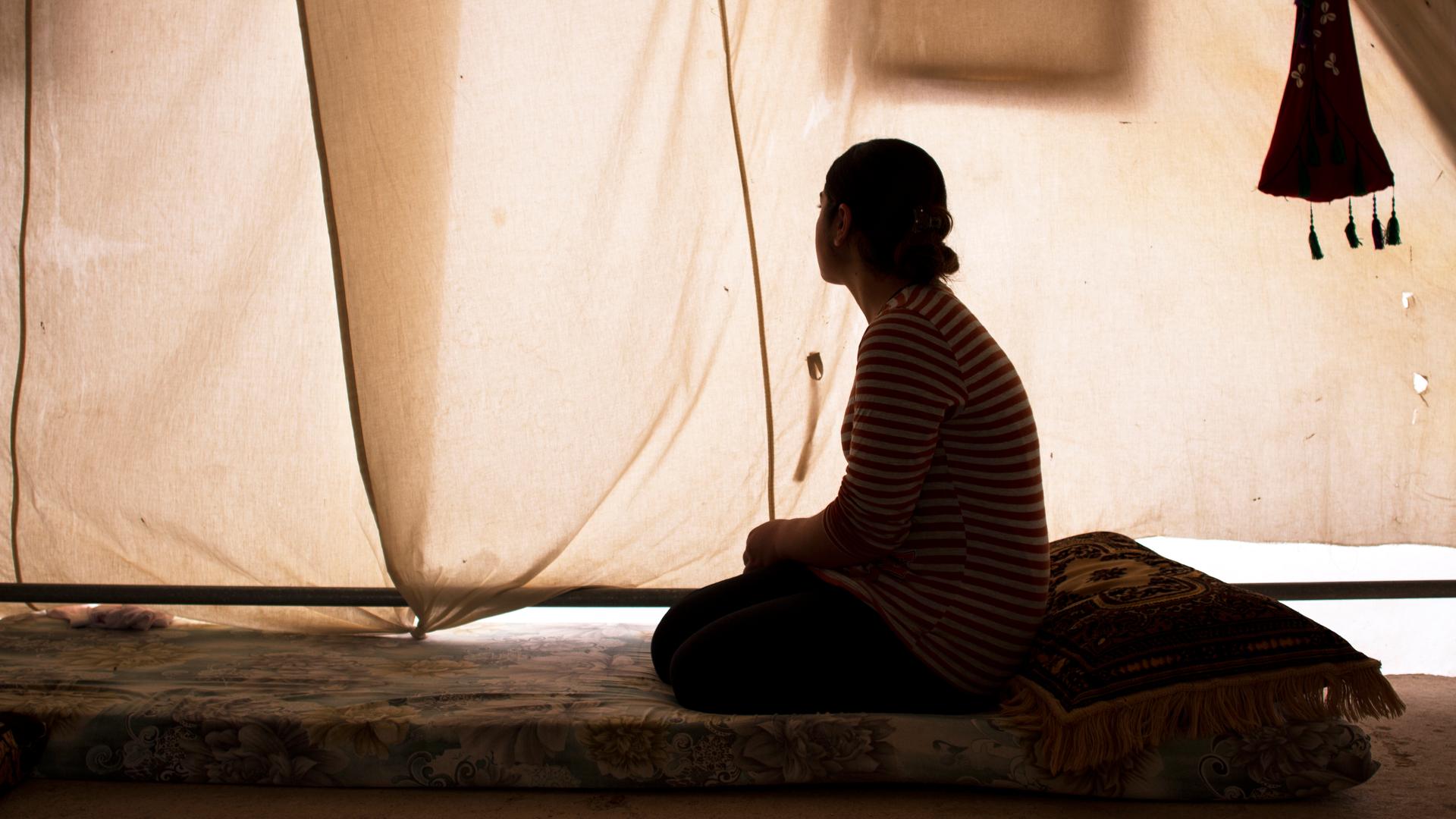 Nour in a tent allocated to her uncle and his family in a camp for displaced people in Dohuk, northern Iraq.