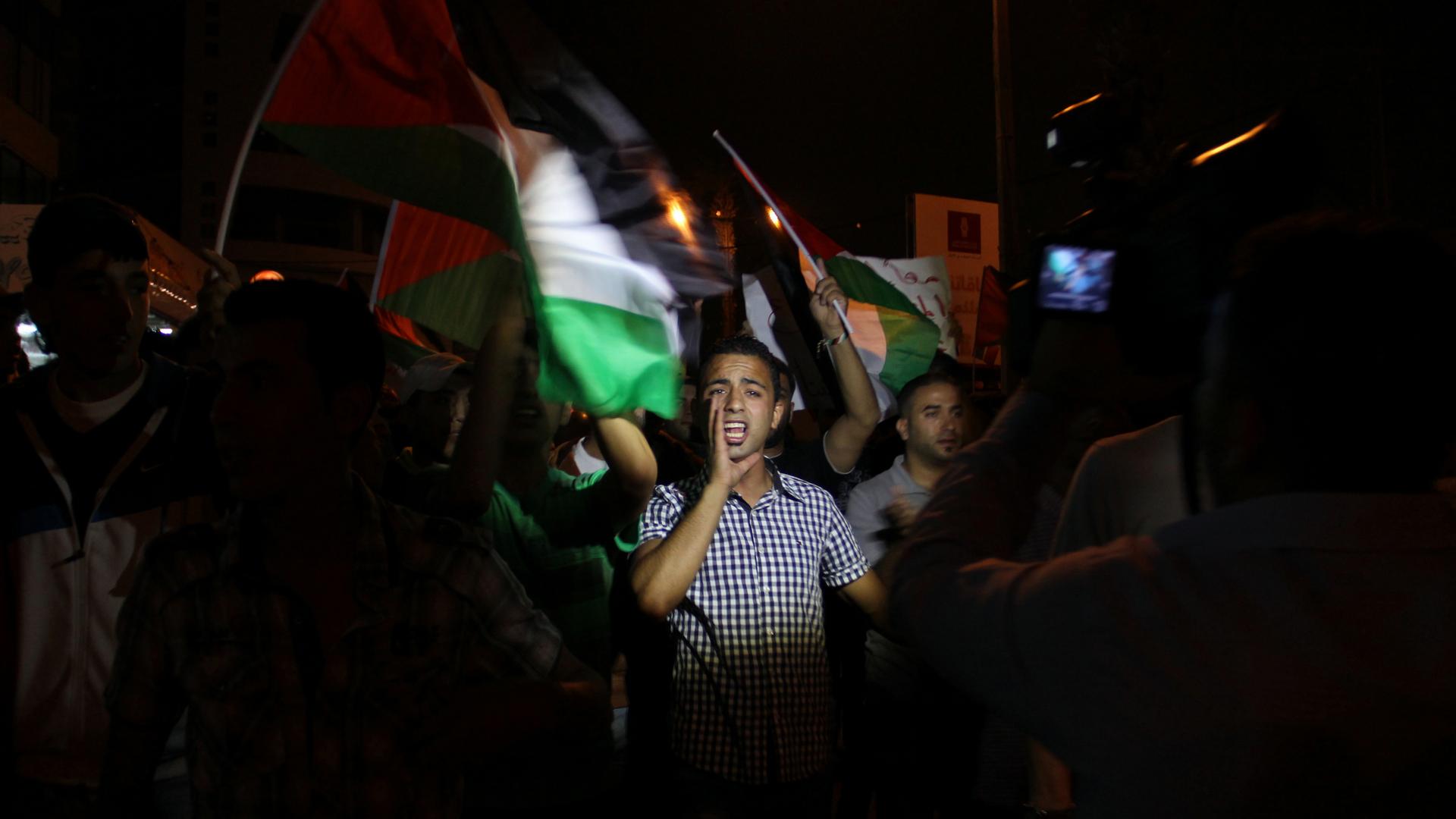 A young Palestinian man chants against Israel’s offensive in the Gaza Strip as he marches from Ramallah toward the Israeli settlement and military base at Beit El. 