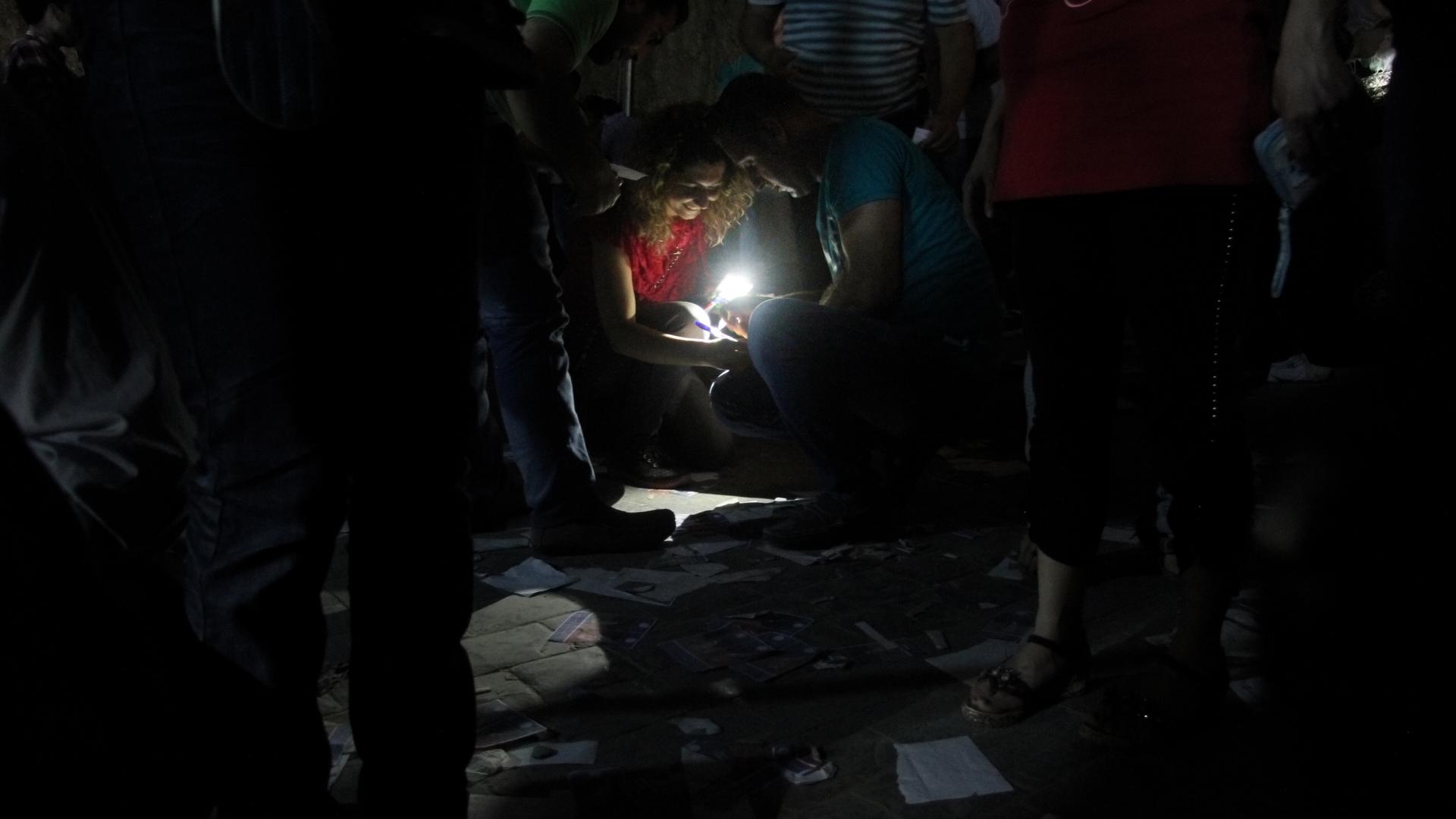 As the sun went down, voters at the Syrian Embassy in Beirut filled out ballots by the light of cellphones and flashlights. The Floors of the polling station were littered with scraps of discarded ballots. 