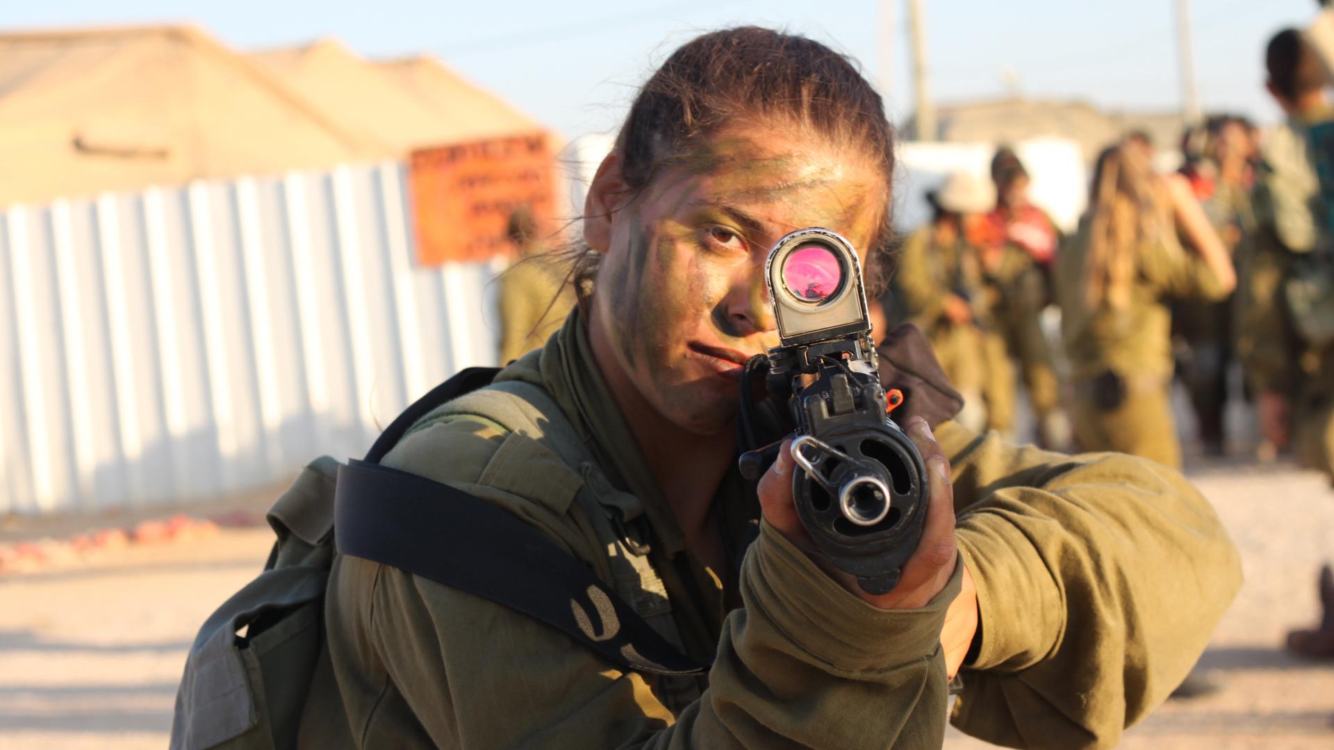 A female Israeli combat soldier poses for a photo.