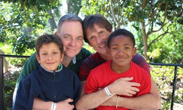 Kevin Fisher-Paulson with his husband Brian and his sons Zane (right) and Aiden.