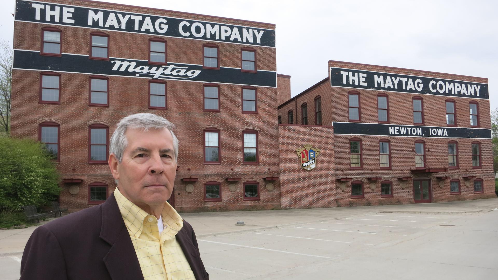 Frank Liebl, executive director of the Newton Development Corporation, in front of the old Maytag headquarters. Community leaders are working to rent out the space, where 2,000 people once worked.