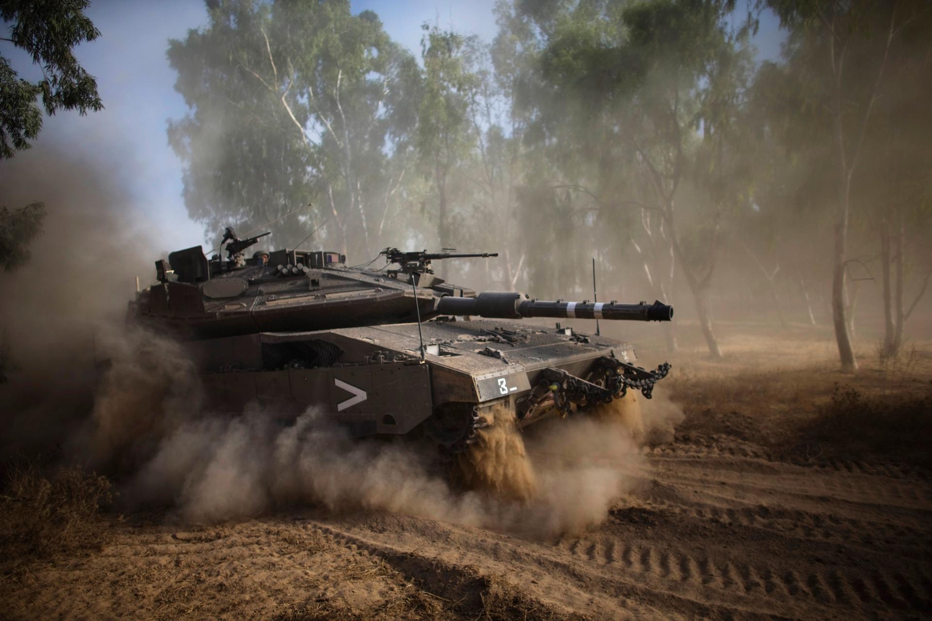 An Israeli tank performs a maneuver after the end of a five-hour humanitarian truce, near the border with the Gaza Strip. Israeli leaders ordered a ground operation in Gaza soon after the temporary ceasefire, which was not honored by Palestinian militant